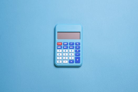 Modern calculator, business and financial accounting concept on blue background photo