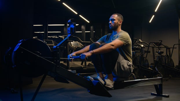 Sport hard weight exercise sporting bodybuilding workout gym pulling rowing machine sitting lift low row motivation healthy African American man sporty male guy athlete sportsman bodybuilder trainer photo