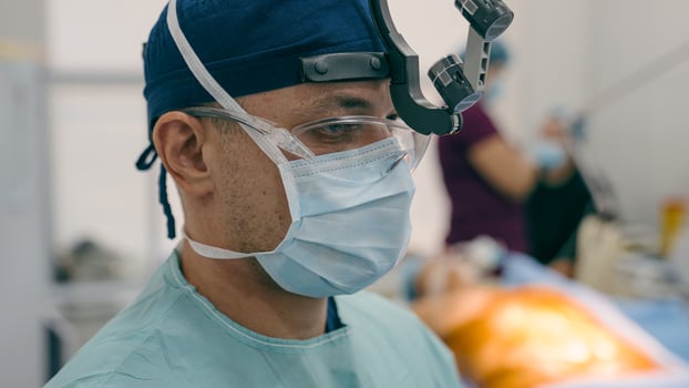 Close up man doctor professional surgeon physician in medical uniform binocular. Team of medics prepare for operation in surgery room on background copy space hospital medical and health care services photo