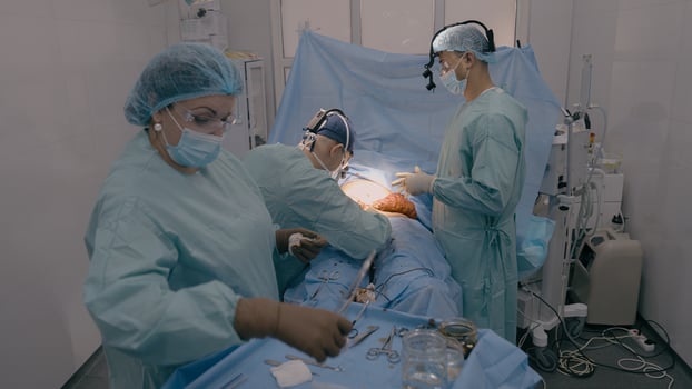 Surgery team professional doctors surgeons perform surgical operation stomach laparoscopy medical equipment nurse assistant give sterile instruments patient health treatment in operating room hospital photo