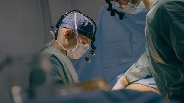 Team of men surgeons paramedics doctors operate patient laparoscopic gastric surgery operation on stomach emergency medical aid procedure in operating room professional health care surgical treatment photo