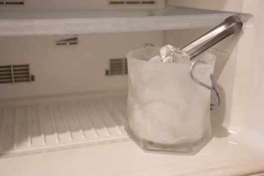 Ice cubes in the bucket in a fridge freezer photo