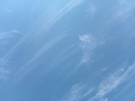 Delicate clouds on a clear blue sky photo