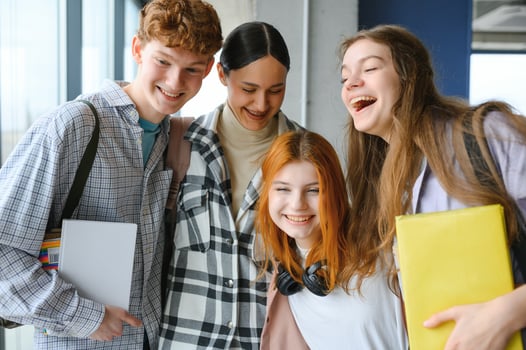 Happy diverse college students posing for group portrait, looking at camera, smiling photo