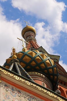 The dome of the orthodox church st. Basil's Cathedral with a cross on Red Square in Moscow. photo