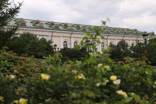 The blurred garden in front and architecture building on the background. photo