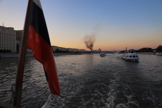 Blurred Russian flag on the background of the fire and Moscow River in Moscow. photo