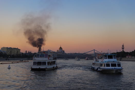 Cruise tour on the Moskva river, fire with smoke in the city centre of Moscow. photo