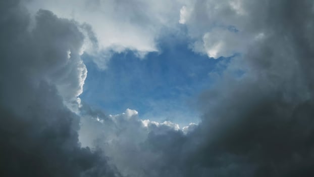 Storm clouds and hole with blue sky photo