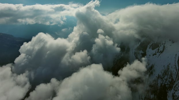 Flying through clouds between mountains photo