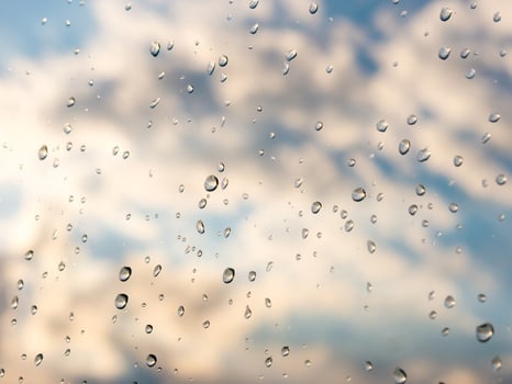 Water drops of rain on blue glass background. Rain drops on window photo