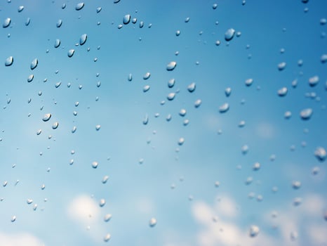 Water drops of rain on blue glass background. Rain drops on window. Shallow DOF. photo