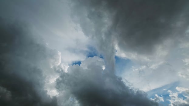 Storm clouds and hole with blue sky photo