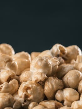 pile of caramel corn on black background photo