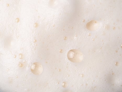Beer or cappucino foam with bubbles texture photo