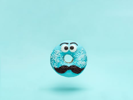 Blue glazed donut with mustache flying photo