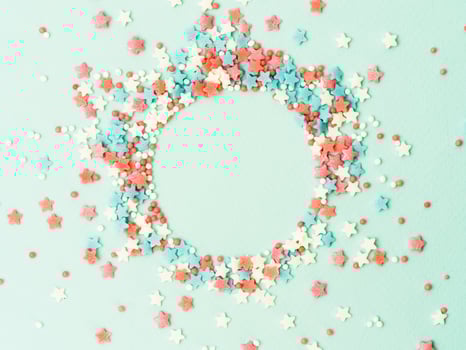 Sprinkles in round spahe on blue, copy space photo