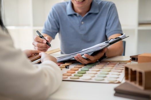 A close-up image of an expert interior designer or architect having a meeting with his client. photo
