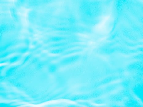 Ripple water texture with shadows on blue photo