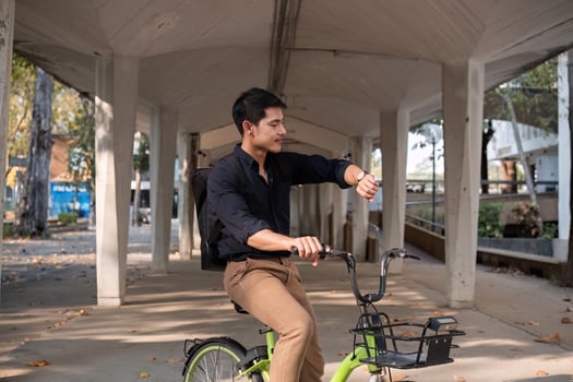 Young Asian businessman Go to work by cycling to reduce air pollution and stay healthy. photo
