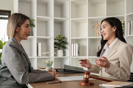 A young lawyer and businesswoman are discussing legal advice on signing a business contract. Insurance or financial contract signing photo