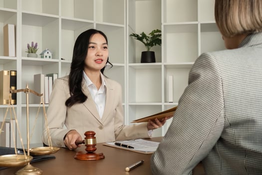 A young lawyer and businesswoman are discussing legal advice on signing a business contract. Insurance or financial contract signing photo