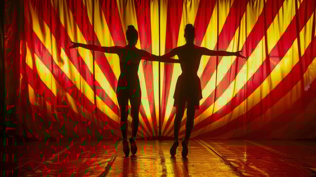 Two acrobats with arms linked silhouettes standing out against the vibrant red and yellow stripes of the circus backdrop. . photo