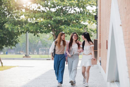 Group of Young Asian student walking and talking at university before class room. education, back to school concept photo