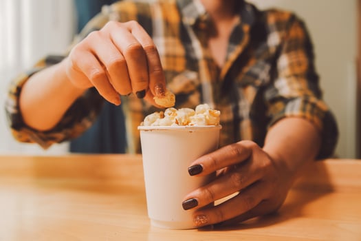 A woman holding a bowl of popcorn photo