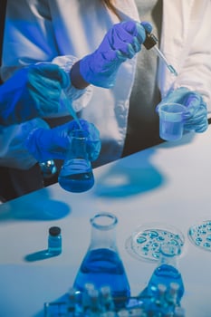 chemist,scientist hand dropping chemical liquid into test tube, science research and development concept photo