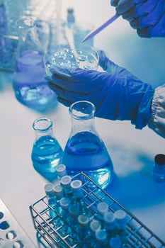 chemist,scientist hand dropping chemical liquid into test tube, science research and development concept photo