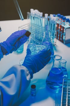 chemist,scientist hand dropping chemical liquid into test tube, science research and development concept photo