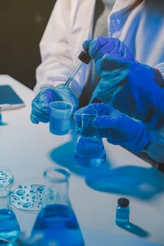 chemist,scientist hand dropping chemical liquid into test tube, science research and development concept photo