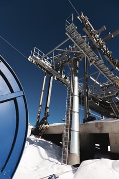 A cable car station high in the mountains under construction. Snowy mountain landscape and construction of a metal structure for a cable car photo