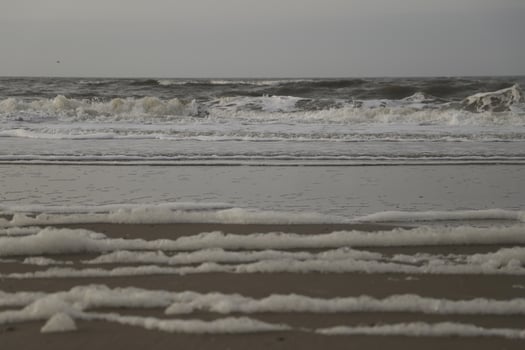 high tide line on the beach, separation between sea and beach photo