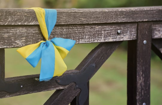 Ribbons in the colors of the national flag of Ukraine are tied to the handrail photo