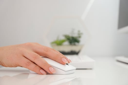 Woman typist using white keyboard and mouse to type and use computer photo