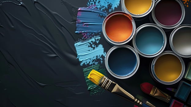 Paint cans and brushes on a black background photo