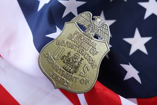KYIV, UKRAINE - MARCH 9, 2024 US FBI Federal Bureau of Investigation badge on United States of America flag photo