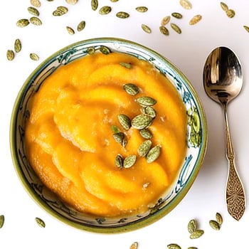 Healthy pumpkin porridge in bowl with spoon photo