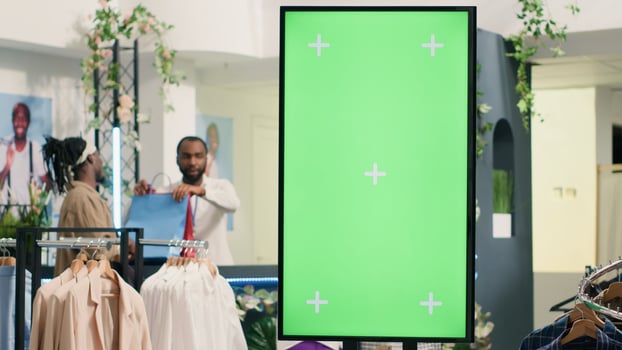 Second hand clothing shop green screen kiosk ready to be used by clients to choose between clothes. Chroma key digital display in thrift shop showcasing available garments sizes photo