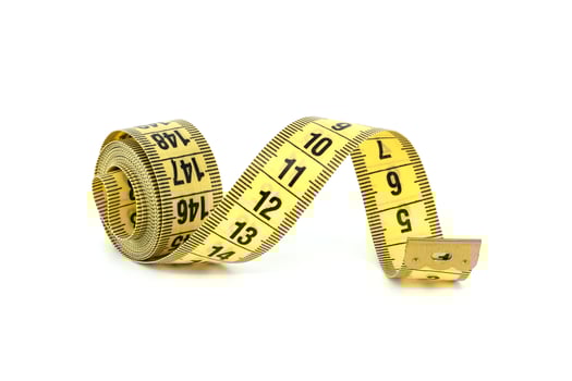 Yellow measuring tape, spirals gracefully, isolated on white photo
