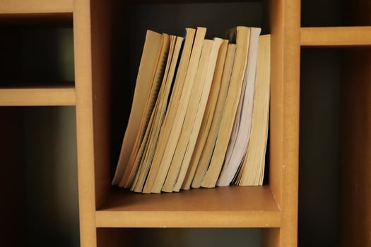 A lot of books are on the shelf in a public library or bookstore photo