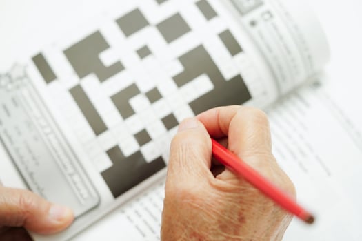 elderly woman playing sudoku puzzle game for treatment dementia prevention and Alzheimer disease. photo