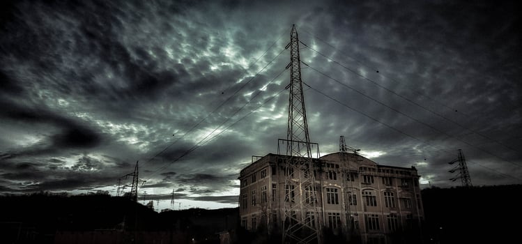 Electricity factory with long-abandoned high voltage cables. dark and noir setting with cloudy sky photo