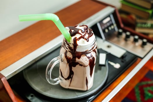 Glass of Chocolate Milkshake With Green Straw photo