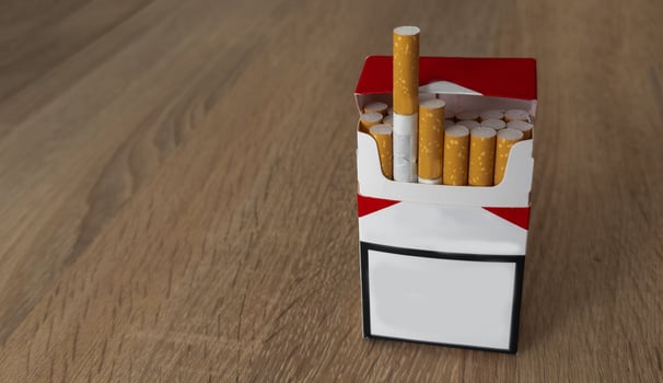 Pack of cigarettes on wooden textured table photo