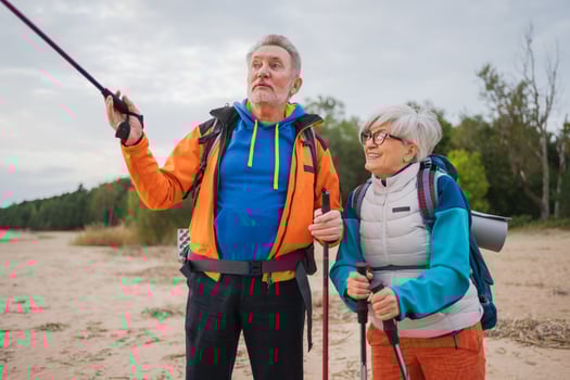 Hiking tourism adventure. Senior couple man woman enjoying outdoor recreation hiking on beach. Happy old people backpackers hikers enjoy walking hike trekking tourism active vacation beauty of nature photo