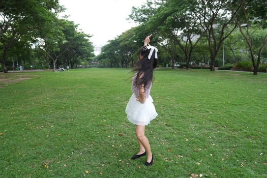 A joyful young woman dances in harmony indoors, with b eautiful greenery and lush plants enhancing the harmony and peace. photo