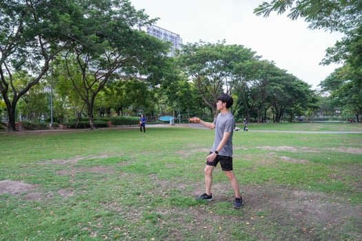 Young people play badminton and repair diligently in the park area. photo